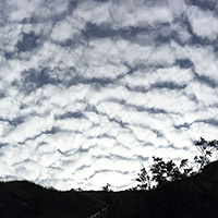 Dramatic furrowed clouds above the trail.